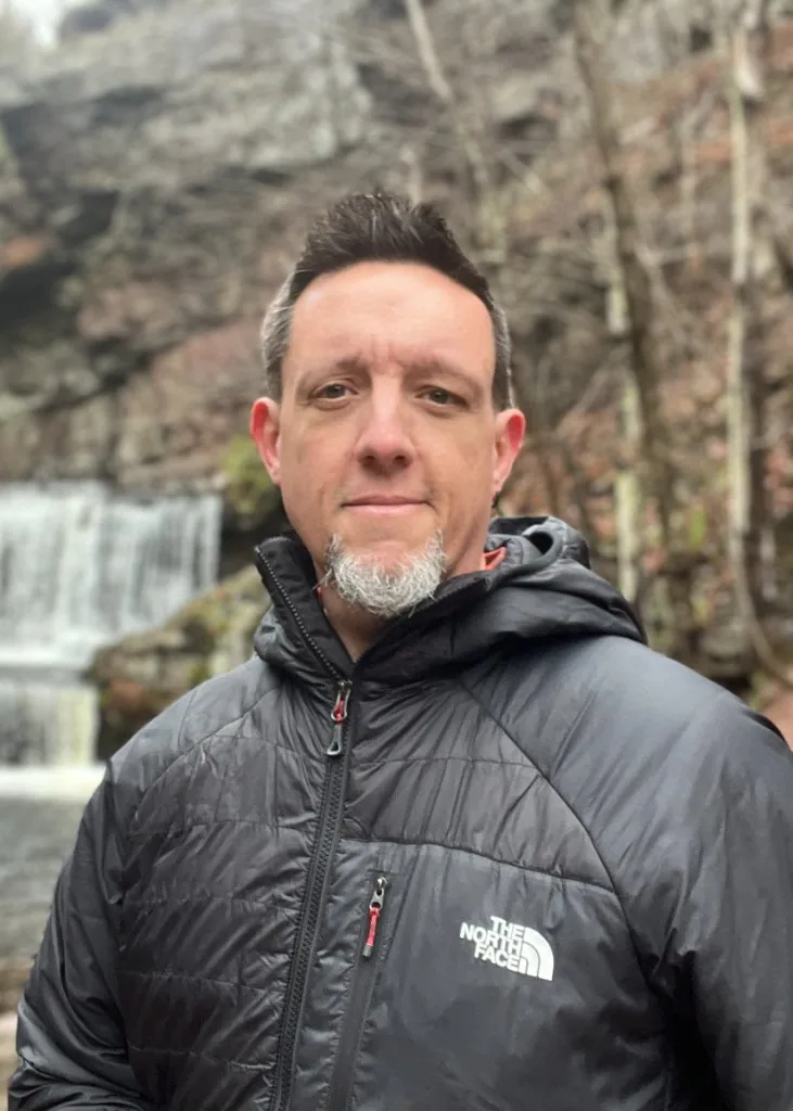 Sven Masterson beside a waterfall on a wilderness walk in Pennsylvania