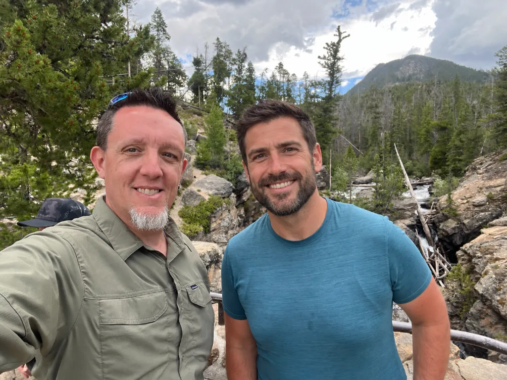 Hikers pausing beside a mountain stream on a full-day coaching walk